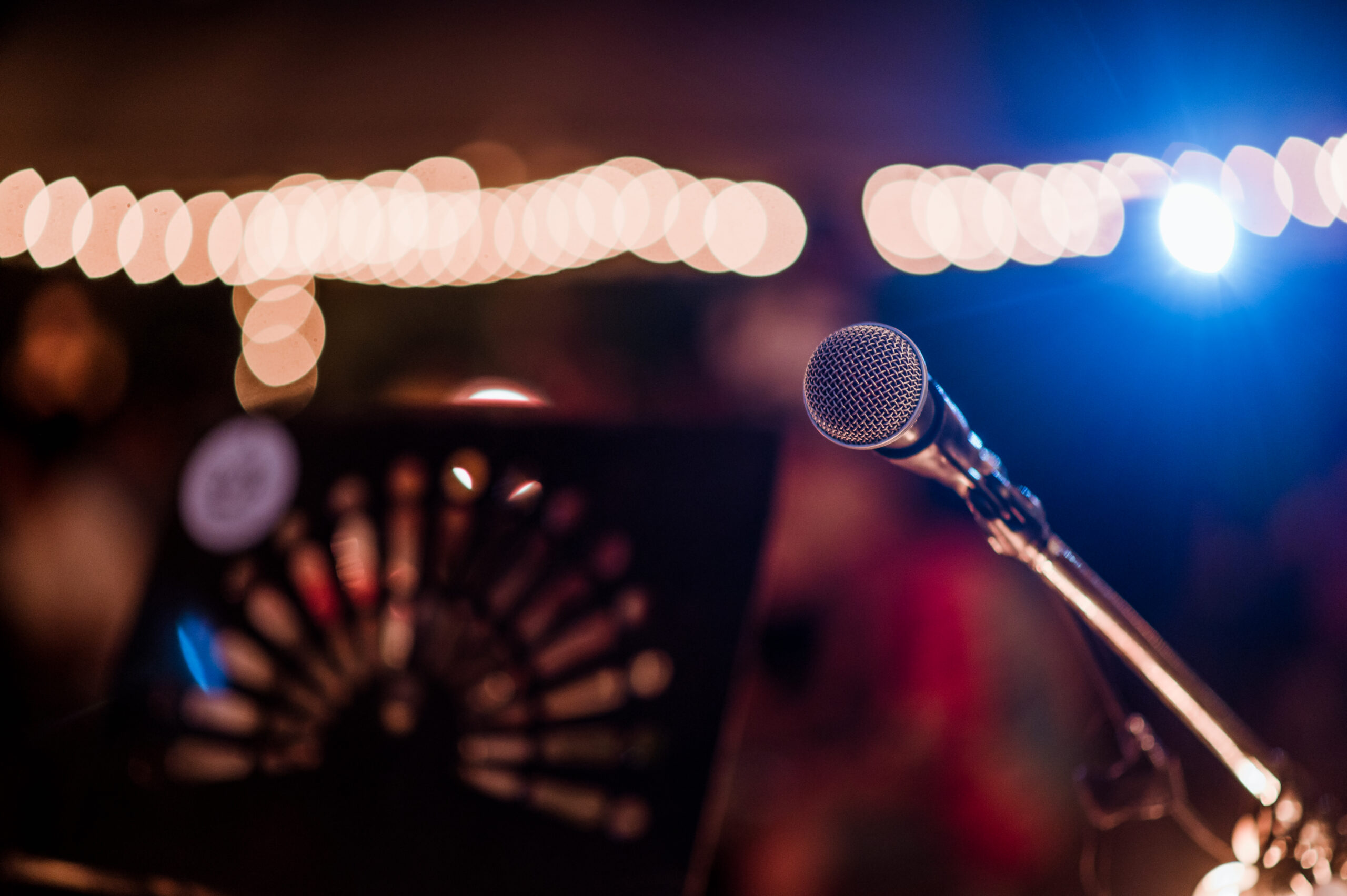 Microphone head on stage in a dark room. Concert,mini concert and music festivals.
